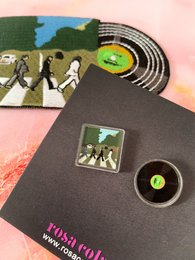 Stud earrings featuring the iconic Abbey Road album cover design by The Beatles. Includes the classic silhouette of the four band members walking across the street.