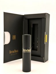Refillable travel perfume in a sleek black container with a minimalist design. Compact size for easy portability.