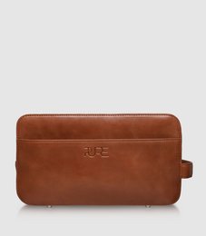 Cognac-colored toiletry bag with a sleek, rectangular shape and a zipper closure. Made of durable, high-quality material suitable for men's grooming essentials.