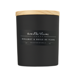 A tall, round black candle with a wooden lid and a glass vase with a green plant inside, set in a wooden crate.
The product appears to be a scented candle with a matte black finish. The candle has a wooden lid and is accompanied by a glass vase containing a green plant. The overall presentation suggests a natural, minimalist aesthetic.