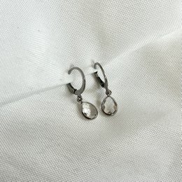 Silver hoop earrings with dangling crystal accents.