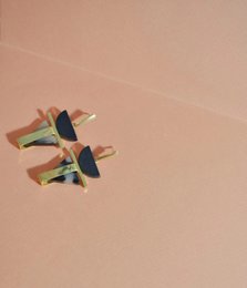  Triangular black statement earrings with colorful geometric accents.