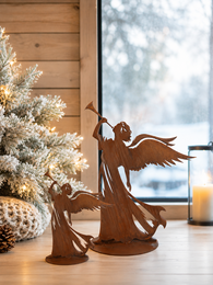 Rust-brown angel figurine, winged decorative sculpture, metal finish, standing pose, Christmas decoration.