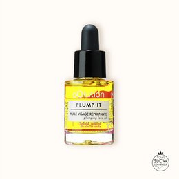 Plump It is a nourishing face oil with a golden yellow color. It is packaged in a glass bottle with a dropper applicator. The product is designed to hydrate and plump the skin.