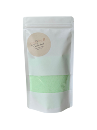 Light green tealight candle with a burning sand scent.