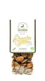 Roasted almonds with thyme, organic dried nuts, brown tan color, natural healthy snack, aromatic herbs