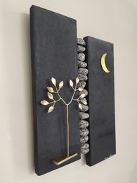 Dark canvas painting with gold tree and moon motifs.