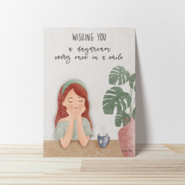 A greeting card with a hand-drawn illustration of a woman and text that says "Wishing you a day that's as lovely as you are." The card has a neutral-colored envelope.