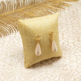 Elegant drop earrings featuring delicate pearls and a shimmering gold-toned finish. Available in a variety of soft, pastel color options.