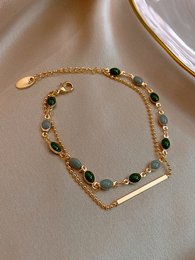 Gold alloy bracelet with black and pearl beads, coil design, elegant jewelry accessory