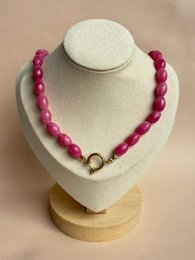 # Product Description

Fuxia pink beaded necklace with round polished stones and gold-tone metal clasp.