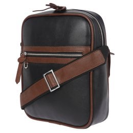 A black and brown leather crossbody bag with multiple zippered compartments and an adjustable strap.