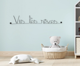 Wire wall art with the text "Live Your Dreams" in a minimalist, modern design suitable for a kid's room or nursery.
