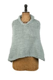  "Sage green knitted poncho, sleeveless, textured wool blend, relaxed fit, cozy layering piece"