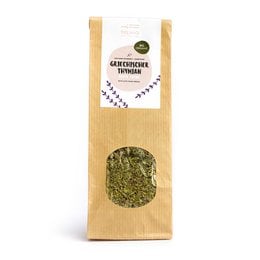 Organic thyme in a paper bag. The thyme is dried and has a green color. The bag has a label with the product name and weight options.