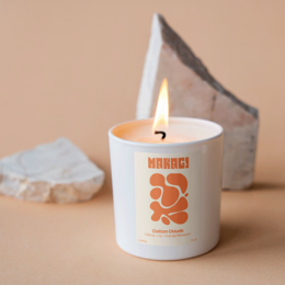 Fragrant cotton clouds candle with citrus, violet, and orange blossom scents, featuring a wooden wick.