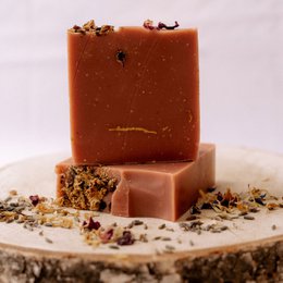 Handmade Provence-style soap bar with natural ingredients like essential oils and herbs. Features a warm, earthy scent and a rustic, artisanal appearance.