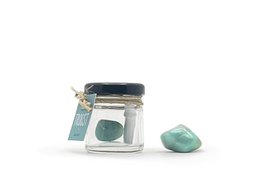  A glass jar containing a smooth, polished amazonite crystal. The jar has a metal lid and the amazonite stone has a beautiful teal-green color.