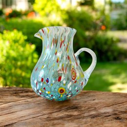  "Colorful Murano glass carafe with a unique swirling pattern in shades of blue, green, and red. Ideal for serving water, juice, or wine."