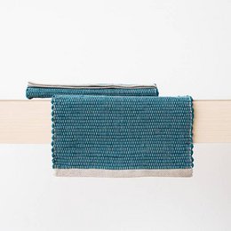 Linen hand-woven placemat in a deep marine blue color, featuring a textured, woven pattern and a simple, elegant design.