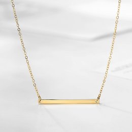 Gold plated necklace with a horizontal bar pendant.