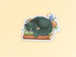  Colorful vinyl sticker featuring a tired orange cat curled up and sleeping, with the text "Not Today" above it. The sticker has a whimsical, hand-drawn style and includes a small flower illustration.
