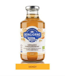 Organic honey in a glass bottle. Honey-colored liquid with a bee on a honeycomb.