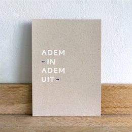 A simple, minimalist postcard with the text "ADEM IN ADEM UIT" printed in white on a beige background.