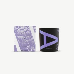 Palo scented candle in a round, tall glass container with a black label featuring the letter "A". The candle has a lavender-colored wax and a floral, earthy scent.