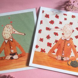 "Mr. & Mrs. Poodle Art Print Set, 21 x 21 cm - Posters featuring two poodle characters, one drinking coffee and the other tea, with a whimsical, illustrated style."
The product is a set of two art prints featuring poodle characters. The prints have a whimsical, illustrated style with warm, earthy tones. One print shows a poodle character drinking coffee, while the other shows a poodle character drinking tea. The prints have a square format measuring 21 x 21 cm.