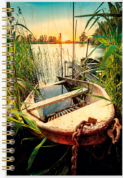 Wooden notebook with a rustic, weathered design featuring a boat in a serene lakeside setting surrounded by tall grass and reeds at sunset.