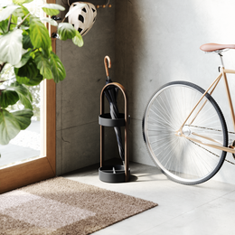 Black walnut umbrella stand, tall curved metal holder, natural wood base, modern minimalist design.