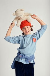A blue long-sleeved t-shirt with a red heart graphic on the front, suitable for children.