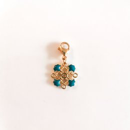 Arabesque - Duck Blue pendant, featuring a cluster of teal and gold beads in a floral design. The pendant has a gold-tone metal setting and is suitable for use as a charm or jewelry accent.