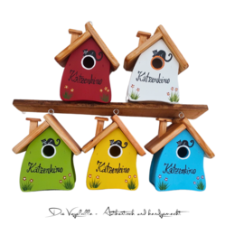 "Colorful wooden bird nesting boxes with house shapes, red white green yellow blue, cat cinema design"