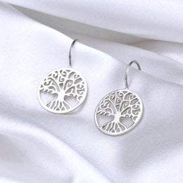 Sterling silver drop earrings featuring a tree of life design. Elegant and minimalist style.