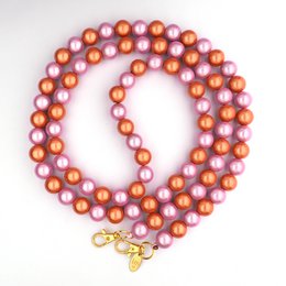 A delicate silver-toned necklace featuring a strand of small, round beads. The necklace has a simple, elegant design that would complement a variety of outfits.