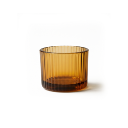 Amber-colored glass tea light holders with a simple, elegant design. Suitable for creating a cozy, warm atmosphere.