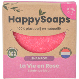 A pink, round shampoo bar with the text "Happy Soap" printed on it. The shampoo bar is made of natural ingredients and is suitable for all hair types.