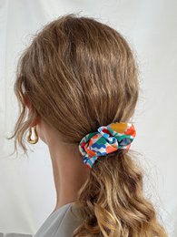 Light blue jacquard scrunchie made from recycled materials, available in mini and maxi sizes.