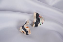 Beige and colorful stud earrings with a unique abstract pattern design.