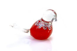 A decorative glass bird ornament in a vibrant red color with intricate white detailing, resembling a stylized bird or feather shape. This unique glass sculpture would make a beautiful addition to any home decor or holiday display.
