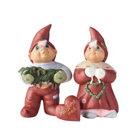 Whimsical elf couple figurines in red outfits, holding a heart-shaped decoration and a bundle of vegetables. Ideal for holiday or seasonal decor.