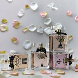 "Elegant perfume collection four bottles gold accents floral design luxury fragrance set ladies"