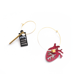 Mismatched hoop earrings with anatomical heart charm, red cork bead, gold and silver options.