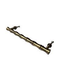  Bamboo brass grabbed large door knob, made of bamboo and brass materials, with a cylindrical shape and a textured surface.