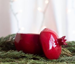 Red pomegranate-shaped jewelry box, glossy ceramic, nature-inspired design, decorative storage container.