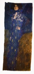 A long, flowing blue scarf with intricate patterns and textures. The scarf appears to be made of a soft, luxurious material like wool or cashmere. The deep blue color and ornate design suggest a high-quality, fashionable accessory.