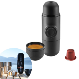 Portable black espresso coffee maker, compact capsule machine with stainless steel cups, travel-friendly design.