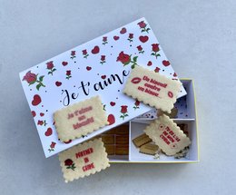 Box of personalized biscuits with the theme "Croque moi!" Includes heart-shaped cookies with the text "Tu es l'as de mon coeur" (You are the ace of my heart) in red.
